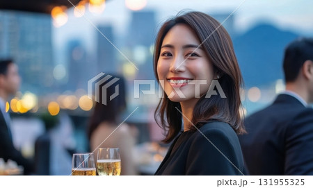 A woman smiles at a rooftop party. 131955325