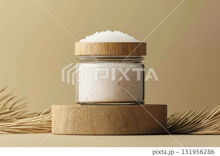 Glass jar with wooden cap full of white powder is standing on a round wooden podium, with dried leaves on each side Glass jar with wooden cap full of white powder is standing on a round wooden podium, with dried leaves on each side 131956286