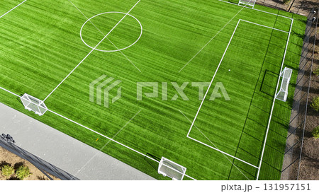 A soccer field with a white line in the middle 131957151