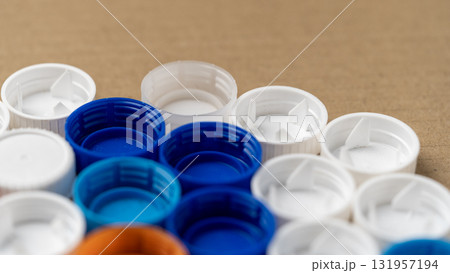 A row of plastic caps with blue and white colors A row of plastic caps with blue and white colors 131957194