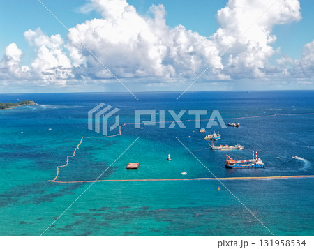 沖縄県大浦湾と遠景の辺野古埋め立て地を空撮した風景 131958534