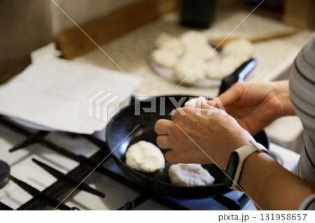 Senior Christmas cook prepares tasty pancake at home Senior Christmas cook prepares tasty pancake at home 131958657