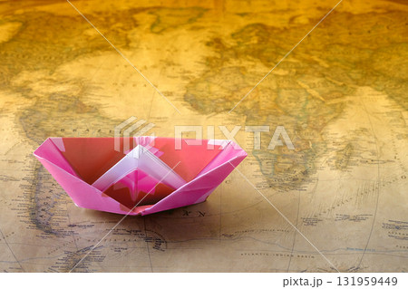 Paper boat or ship on Vintage world map, Paper craft or origami. Paper boat or ship on Vintage world map, Paper craft or origami. 131959449