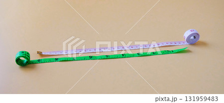 White and Green Measuring tape on color background. 131959483