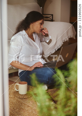 Woman Working From Home On Laptop, Cozy Indoor Scene With Coffee Mug 131960026