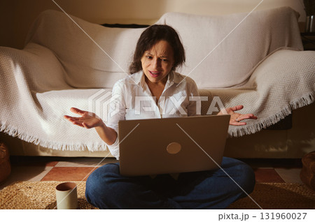 Woman Working On Laptop At Home, Frustrated And Stressed In Living Room Woman Working On Laptop At Home, Frustrated And Stressed In Living Room 131960027