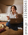Happy Professional Woman Using Laptop And Phone At Home Office, Smiling While On Call 131960043