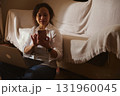 Woman Working From Home With Laptop And Phone In Cozy Living Room 131960045
