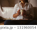 Cozy Home Morning With Coffee Mug, Laptop, And Relaxed Woman On Sofa 131960054