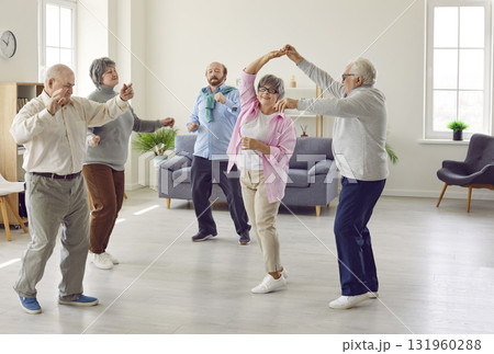 Group of happy smiling senior people men and women having fun and dancing in retirement home. 131960288