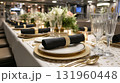 Elegant dining table with gold and black decor at a formal event. 131960448