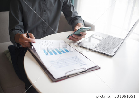 Closeup hand of unrecognizable businessman, entrepreneur, accountant, banker at the workplace 131961051