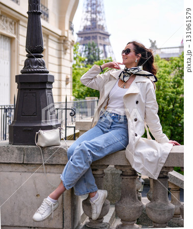 Trendy woman in casual outfit relaxing near Eiffel Tower in Paris 131961579