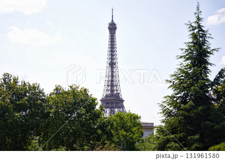 Eiffel Tower above trees and blue sky in Paris Eiffel Tower above trees and blue sky in Paris 131961580