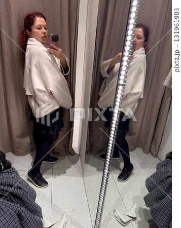 Side view of a woman posing in a beige jacket. Perception of proportion, silhouette, and feminine strength through relaxed elegance and mindful self-image. Side view of a woman posing in a beige jacket. Perception of proportion, silhouette, and feminine strength through relaxed elegance and mindful self-image. 131961903