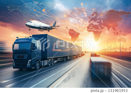 An aerial view shows an airplane soaring above cargo containers, basking in the warm hues of a sunset 131961953