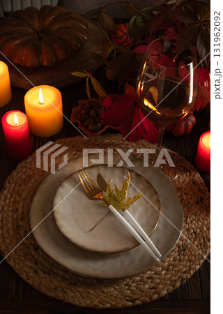 Autumn Table Setting with Plates, Wine, Pumpkins and Seasonal Decor Autumn Table Setting with Plates, Wine, Pumpkins and Seasonal Decor 131962092