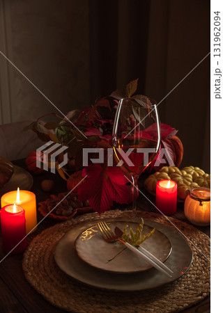Autumn Table Setting with Pumpkins, Candles and Leaf Decor Autumn Table Setting with Pumpkins, Candles and Leaf Decor 131962094