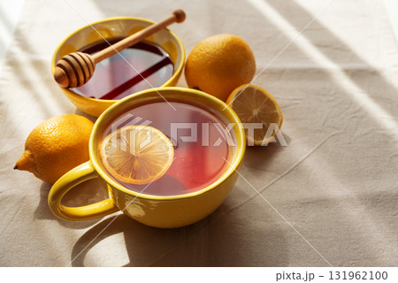 Flat Lay with Lemon Tea and Honey on Light Table under Sun Light Flat Lay with Lemon Tea and Honey on Light Table under Sun Light 131962100