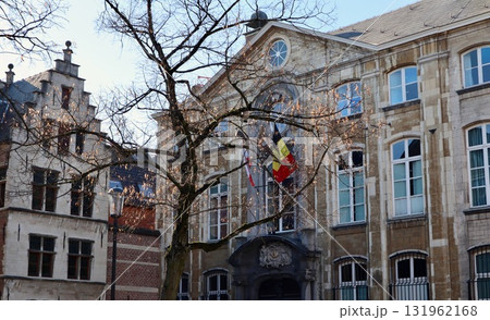 Architectural buildings and a leafless tree in a European city having a flag of Belgium flying. Antwerp, Belgium Architectural buildings and a leafless tree in a European city having a flag of Belgium flying. Antwerp, Belgium 131962168