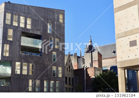 Modern and old architecture creating a contrast in an urban cityscape under bright blue sky. Antwerp, Belgium Modern and old architecture creating a contrast in an urban cityscape under bright blue sky. Antwerp, Belgium 131962184