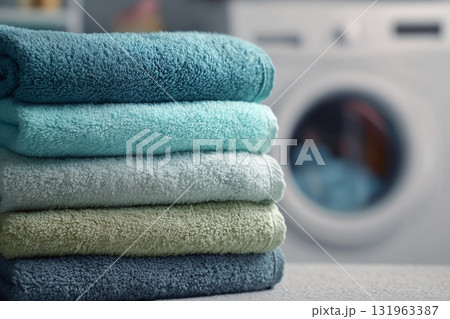 Soft Towels Stacked Neatly in a Laundry Room With a Washing Machine on Display 131963387