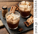 Two glasses of hot chocolate with fluffy marshmallows on a slate board. 131963664