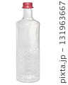 Empty transparent glass bottle with a relief pattern and a red screw cap on an isolated background. 131963667