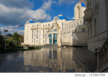 The building of the international academic school in Odessa. The richly decorated building with neoclassical architecture has a central golden dome topped with a cross. The building of the international academic school in Odessa. The richly decorated building with neoclassical architecture has a central golden dome topped with a cross. 131963760