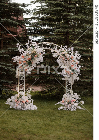 Wedding floral arch with white and pink flowers in garden at sunset 131963940