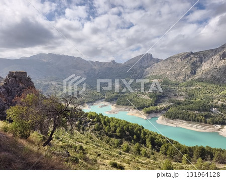 Stunningly Beautiful Mountain Landscape Showcasing Clear, Turquoise Water Beneath a Blue Sky 131964128