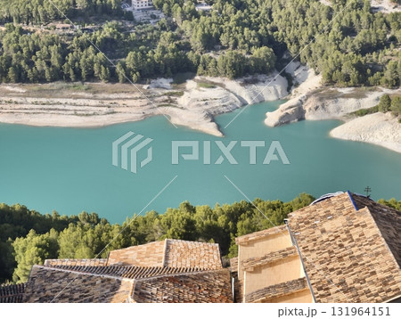 Enjoy the serene aerial view of the stunning turquoise lake surrounded by lush greenery Enjoy the serene aerial view of the stunning turquoise lake surrounded by lush greenery 131964151