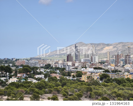 An Urban Landscape Showcasing Beautiful Scenic Mountains Surrounded by a Vibrant City Skyline 131964163