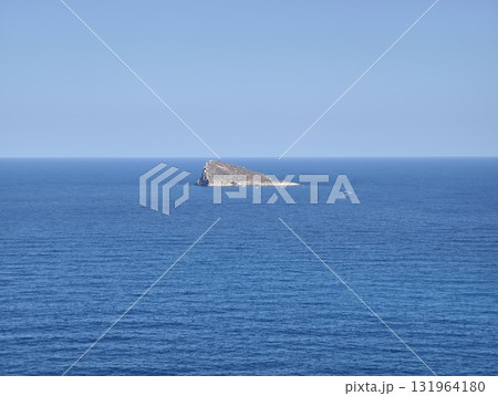 A Serene and Isolated Island, Perfectly Surrounded by a Vast and Tranquil Blue Ocean Landscape A Serene and Isolated Island, Perfectly Surrounded by a Vast and Tranquil Blue Ocean Landscape 131964180