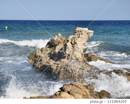 A Truly Stunning Lone Rock Formation Rising Majestically in the Midst of the Ocean Waves A Truly Stunning Lone Rock Formation Rising Majestically in the Midst of the Ocean Waves 131964205