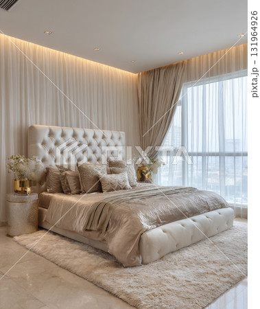 A lavish, serene modern bedroom with an upholstered, tufted headboard and plush bed. Space features a palette of soft, neutral tones and metallic accents, creating luxurious and comfortable sanctuary. A lavish, serene modern bedroom with an upholstered, tufted headboard and plush bed. Space features a palette of soft, neutral tones and metallic accents, creating luxurious and comfortable sanctuary. 131964926