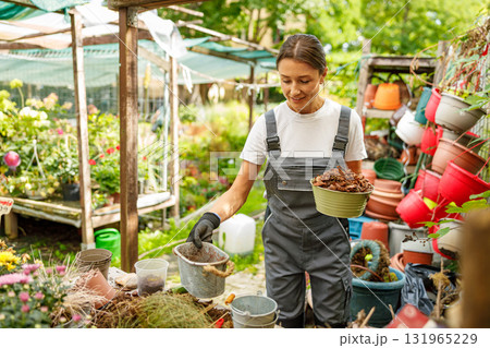 A Dedicated Gardening Enthusiast Who Enjoys Caring for Various Plants in a Greenhouse Space A Dedicated Gardening Enthusiast Who Enjoys Caring for Various Plants in a Greenhouse Space 131965229