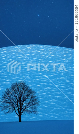 A solitary bare tree stands prominently in a vast, undulating snow-covered landscape under a deep blue night sky filled with tiny sparkling stars, creating a serene winter scene. 131966584