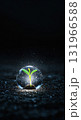 A vibrant green seedling sprouts from dark soil, encapsulated within a clear, glowing sphere, surrounded by shimmering particles against a mysterious black background. 131966588