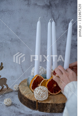 Step by step instruction of making handmade Christmas advent four weeks candle calendar. Female hands creating craft homemade decor. New year celebration. Winter holidays Step by step instruction of making handmade Christmas advent four weeks candle calendar. Female hands creating craft homemade decor. New year celebration. Winter holidays 131967520