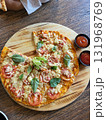This is round of pizza on the table  131968769