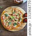 This is round of pizza on the table  131968770