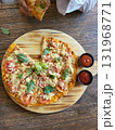 This is round of pizza on the table  131968771