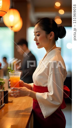 A woman dressed in a vibrant red kimono stands at a bar, holding a refreshing drink. Lanterns illuminate the lively atmosphere of this contemporary dining space. 131969058