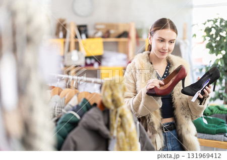 Woman choosing high-heeled shoes in a store Woman choosing high-heeled shoes in a store 131969412