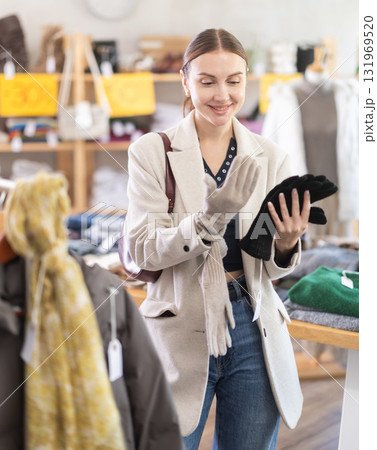 Woman chooses warm gloves Woman chooses warm gloves 131969520
