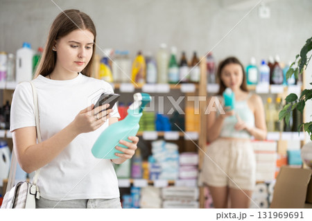 Young woman scanning qr code for cleaning spray 131969691