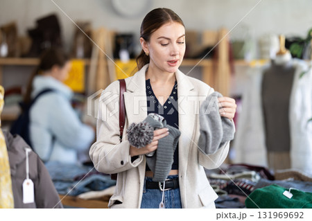 Stylish woman choose hat for autumn-winter season in clothing store. Black Friday sale of winter clothing collection 131969692