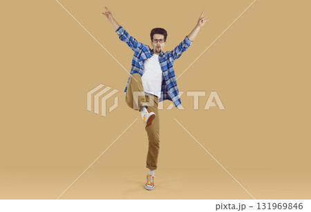 Shot of young man showing rock sign hand gesture Shot of young man showing rock sign hand gesture 131969846