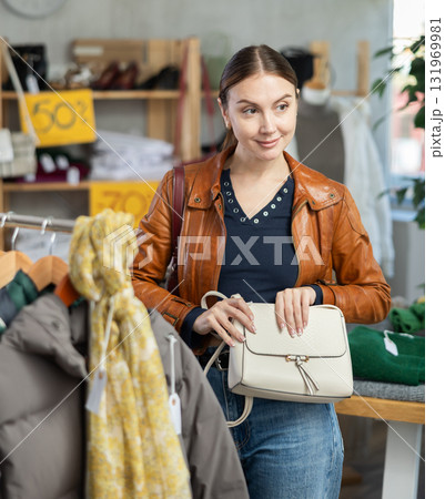 woman in the top one chooses a bag woman in the top one chooses a bag 131969981